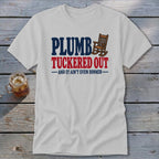 White t-shirt with text "PLUMB TUCKED OUT AND IT AIN'T EVEN DINNER" and a rocking chair.