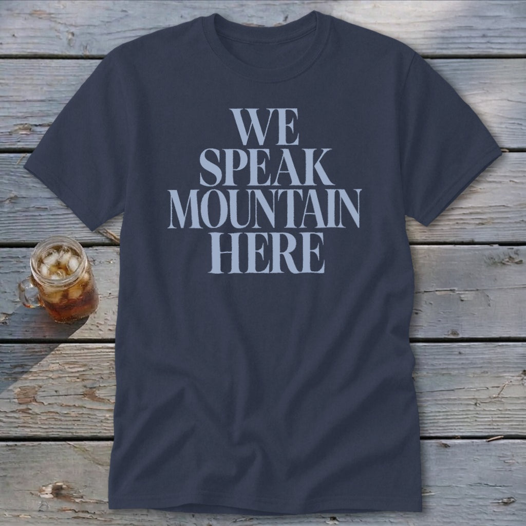 Navy t-shirt with light blue text reading "WE SPEAK MOUNTAIN HERE".