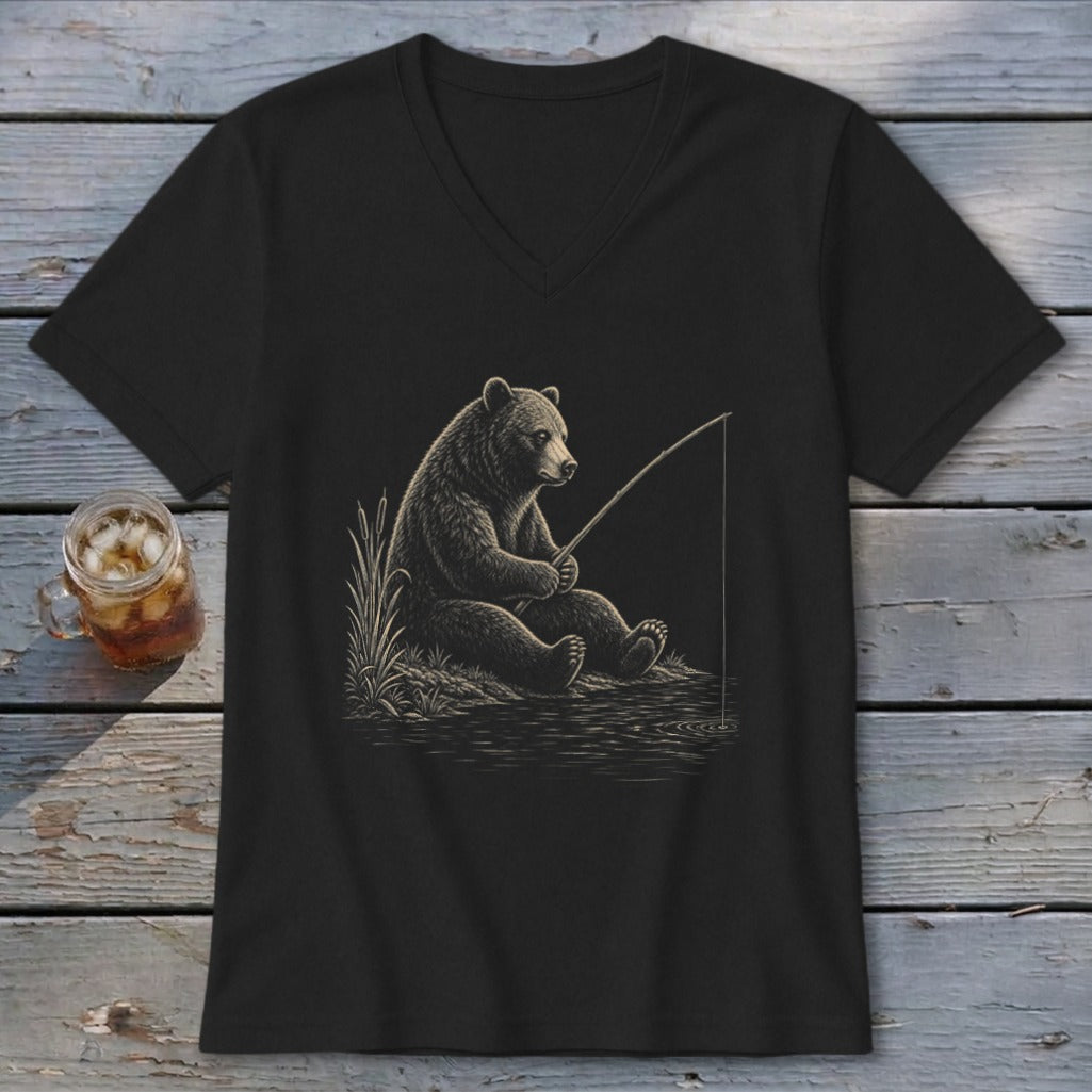 Black t-shirt with a drawing of a bear fishing by the water.