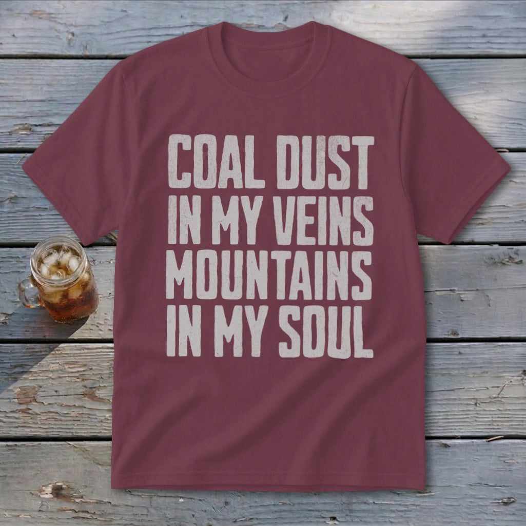 A maroon t-shirt with white distressed text that reads COAL DUST IN MY VEINS MOUNTAINS IN MY SOUL.