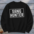 Black sweatshirt with white text reading "SANG HUNTER" in a rectangle.