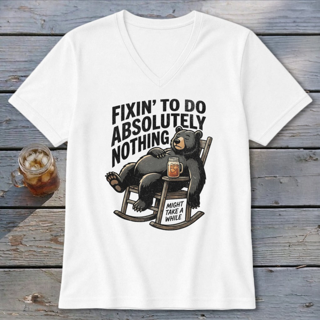 White V-neck t-shirt featuring a graphic of a bear relaxing in a rocking chair with text.