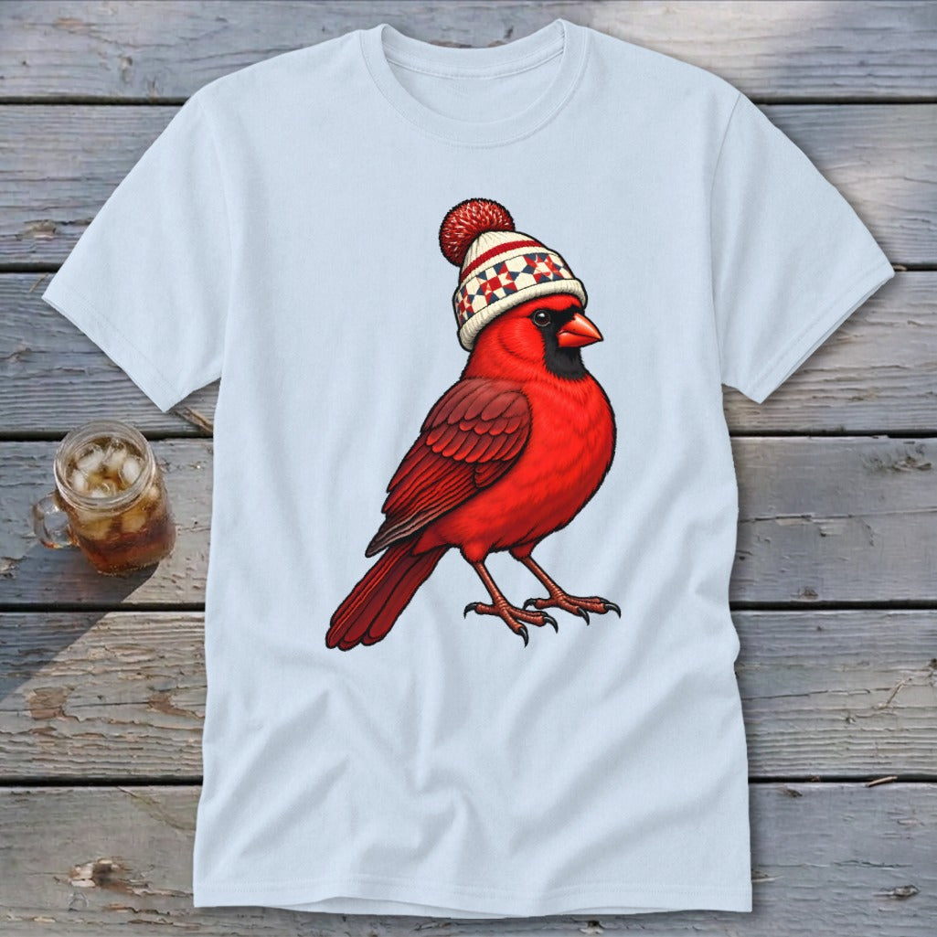 A light blue t-shirt printed with a graphic of a red cardinal wearing a winter beanie.