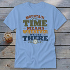 Light blue t-shirt with "MOUNTAIN TIME MEANS WHENEVER WE GET THERE" text and clock graphic.