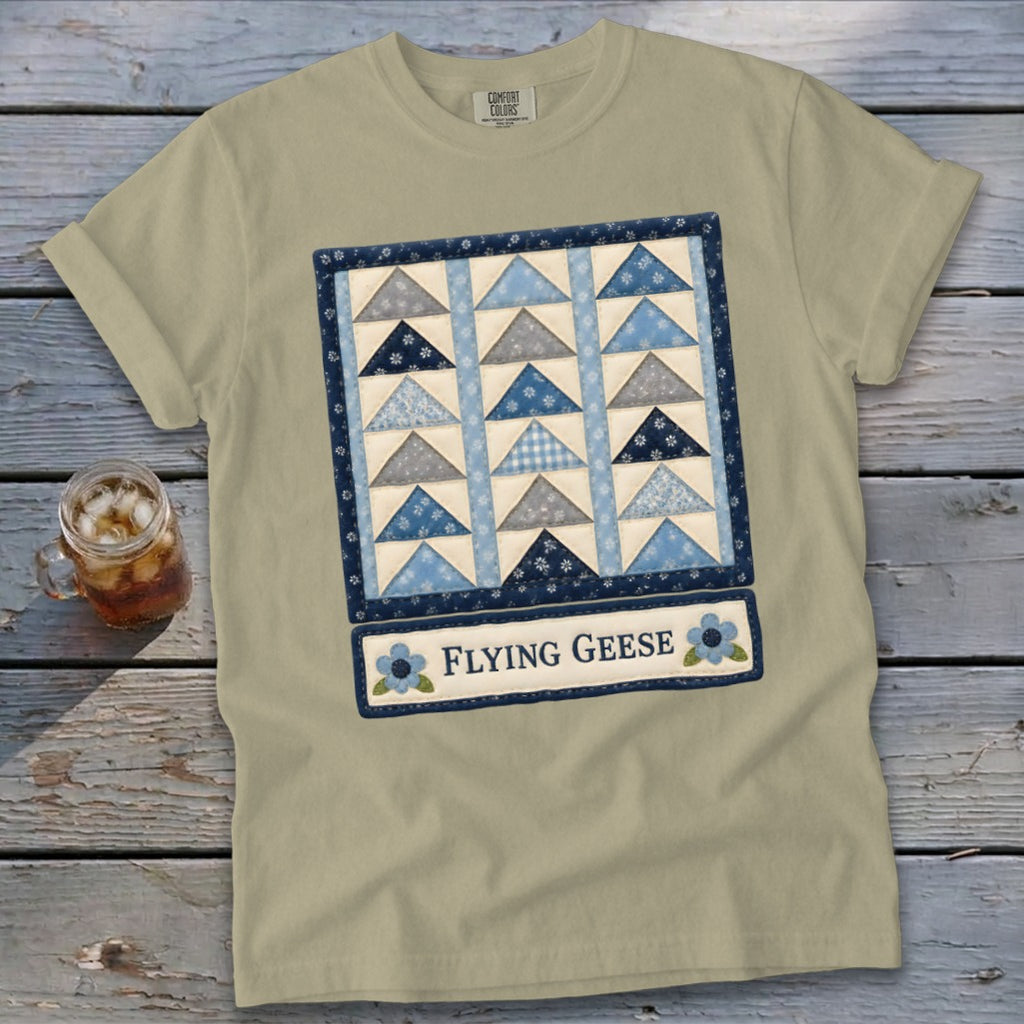 T-shirt with a blue and gray flying geese quilt graphic and text.