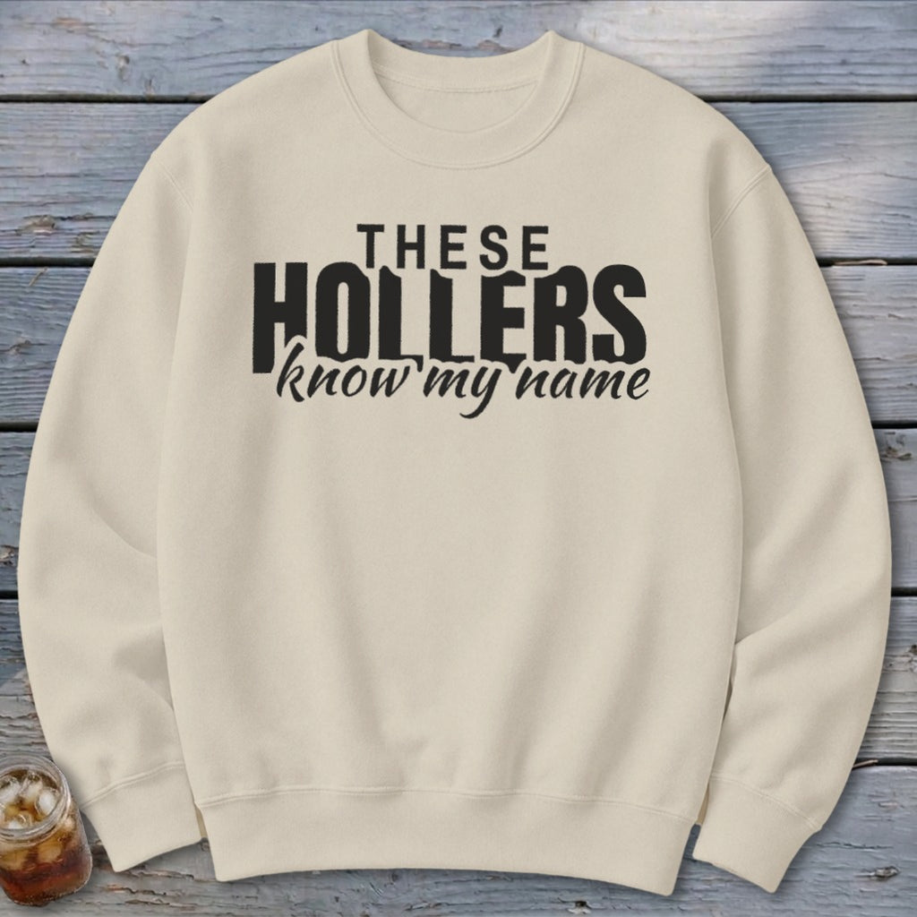 Cream sweatshirt with black text reading "THESE HOLLERS know my name."