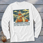 White long-sleeve t-shirt featuring a graphic of stacked pumpkins, hills, and the text Harvest Days in the Highlands.