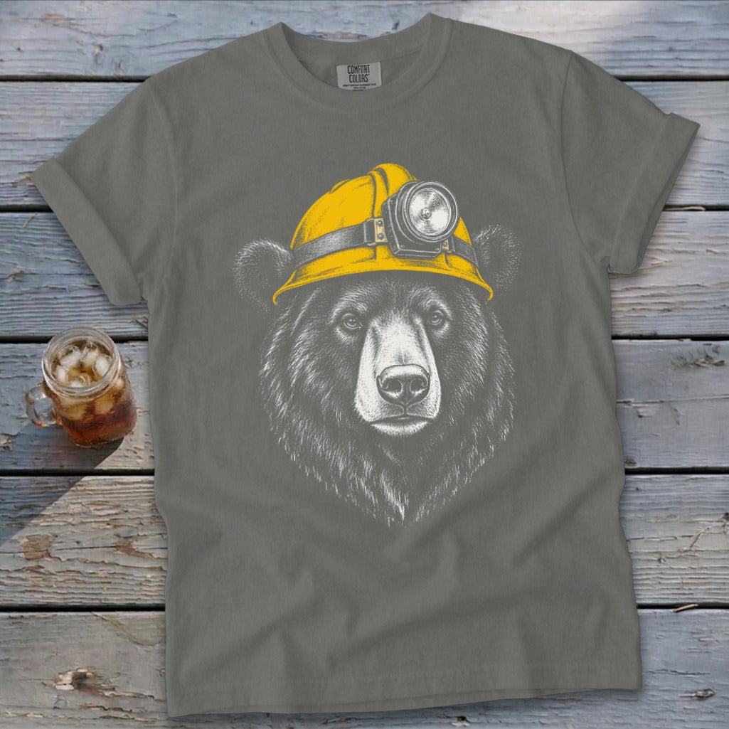 Bear wearing a yellow miner's hard hat with a light on it.