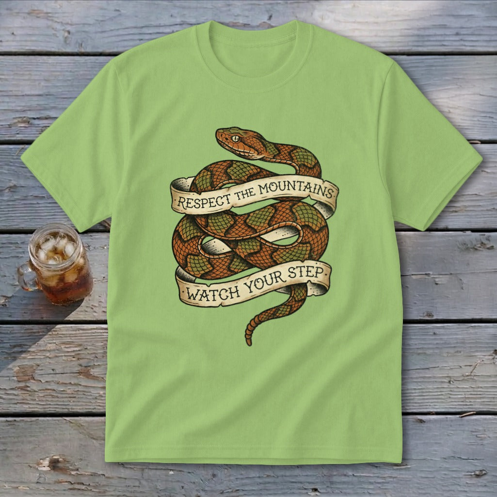 Light green t-shirt with coiled snake and banner text "Respect the Mountains Watch Your Step".