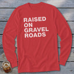 Red long sleeve shirt with "RAISED ON GRAVEL ROADS" in white text.