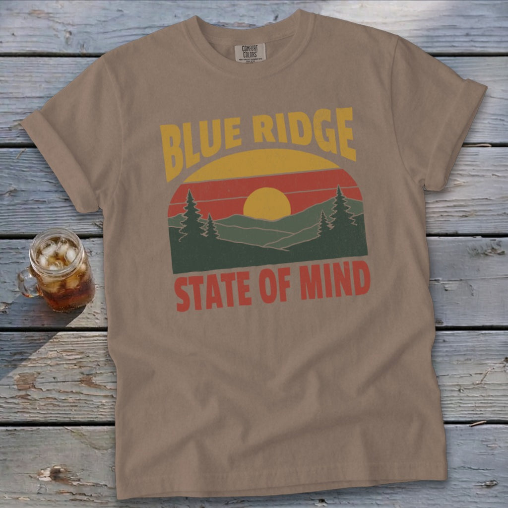 Brown t-shirt with "Blue Ridge State of Mind" text and a retro mountain sunset graphic.