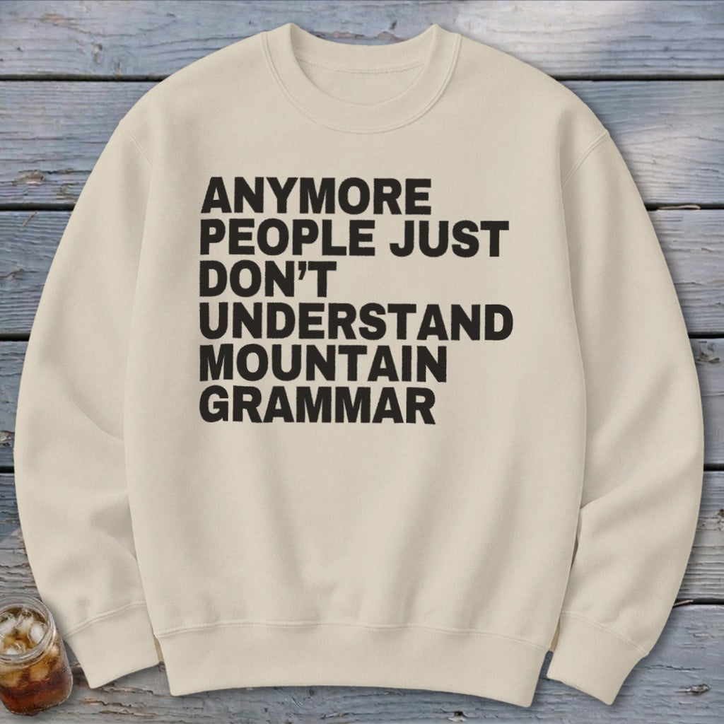 Cream sweatshirt with black text that reads "Anymore people just don't understand mountain grammar."