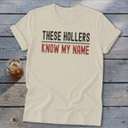 Lightweight t-shirt with "THESE HOLLERS KNOW MY NAME" text in black and red.