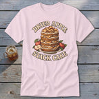 Pink t-shirt with "Dried Apple Stack Cake" graphic featuring a multi-layered cake and apples.