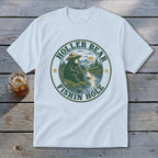 White t-shirt with "Holler Bear Fishin Hole" graphic of a bear fishing by a stream.
