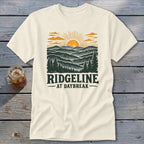 Cream t-shirt with a vintage landscape design and text "RIDGELINE AT DAYBREAK".