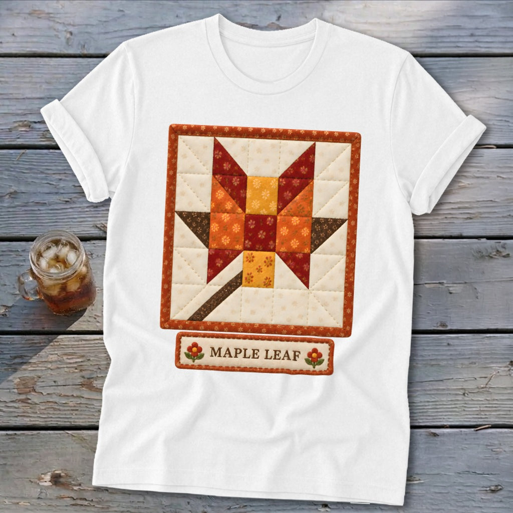 White t-shirt with a quilted maple leaf design and "Maple Leaf" text.