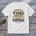 White t-shirt with "Mountain Time Means Whenever We Get There" text and a clock graphic.