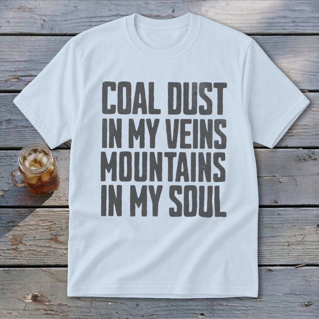 A white crewneck t-shirt featuring the dark grey distressed text COAL DUST IN MY VEINS MOUNTAINS IN MY SOUL centered on the chest.