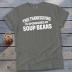 A dark gray t-shirt featuring the white text THIS THANKSGIVING IS SPONSORED BY SOUP BEANS.