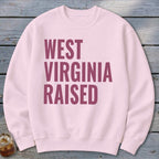 Light pink sweatshirt with "WEST VIRGINIA RAISED" printed in dark pink text.
