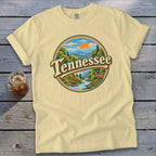 Pale yellow t-shirt with a circular graphic of a Tennessee landscape with a deer.