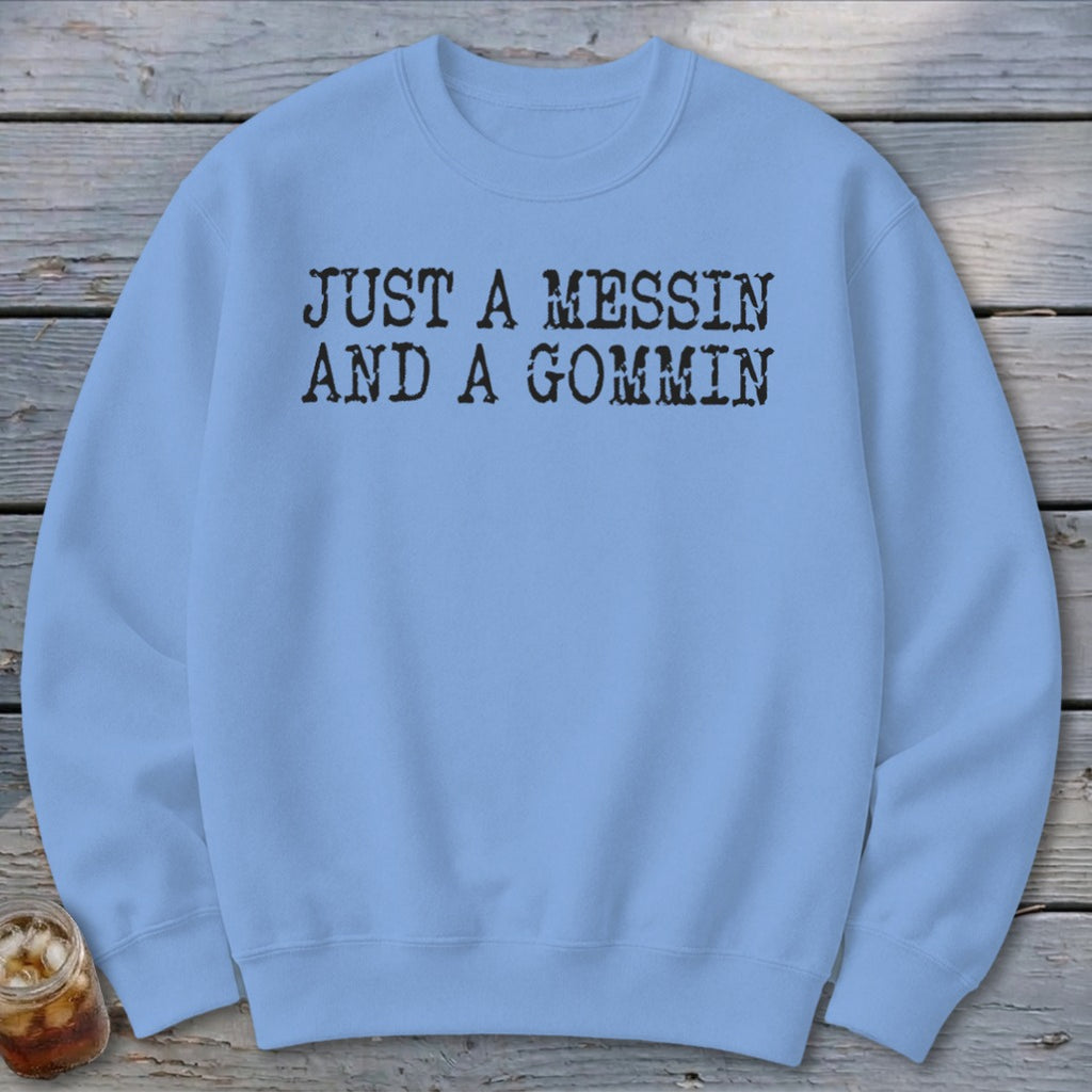 Light blue crewneck sweatshirt with black text that reads "JUST A MESSIN AND A GOMMIN."