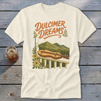 Cream t-shirt with "Dulcimer Dreams" text and a dulcimer on a porch railing.