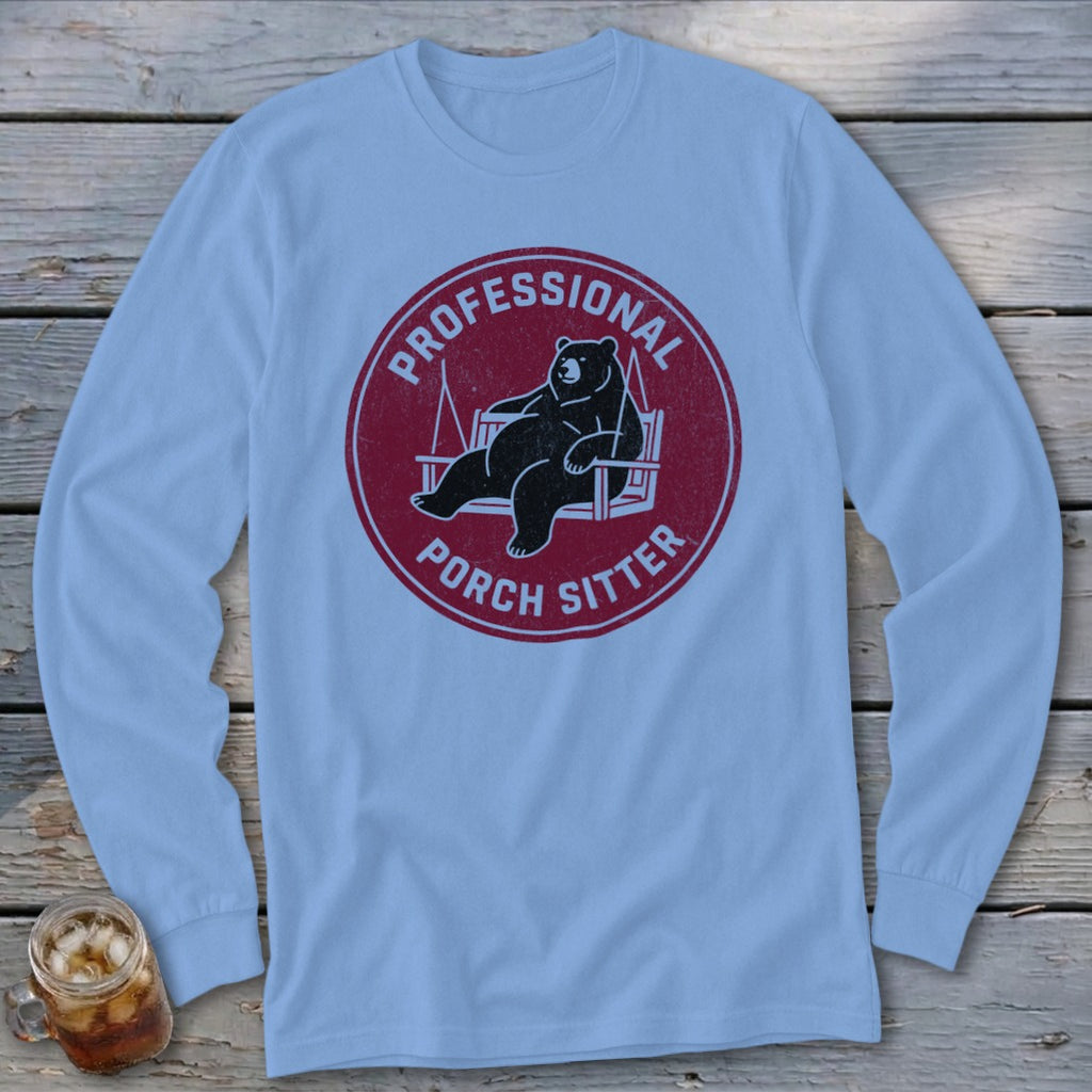 Light blue long-sleeve t-shirt with a maroon circular graphic of a bear in a porch swing, reading Professional Porch Sitter.