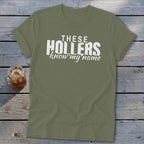 Olive green t-shirt with white text that reads "THESE HOLLERS know my name".