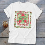 White t-shirt with a red and green floral design and "Mountain Blood" text.