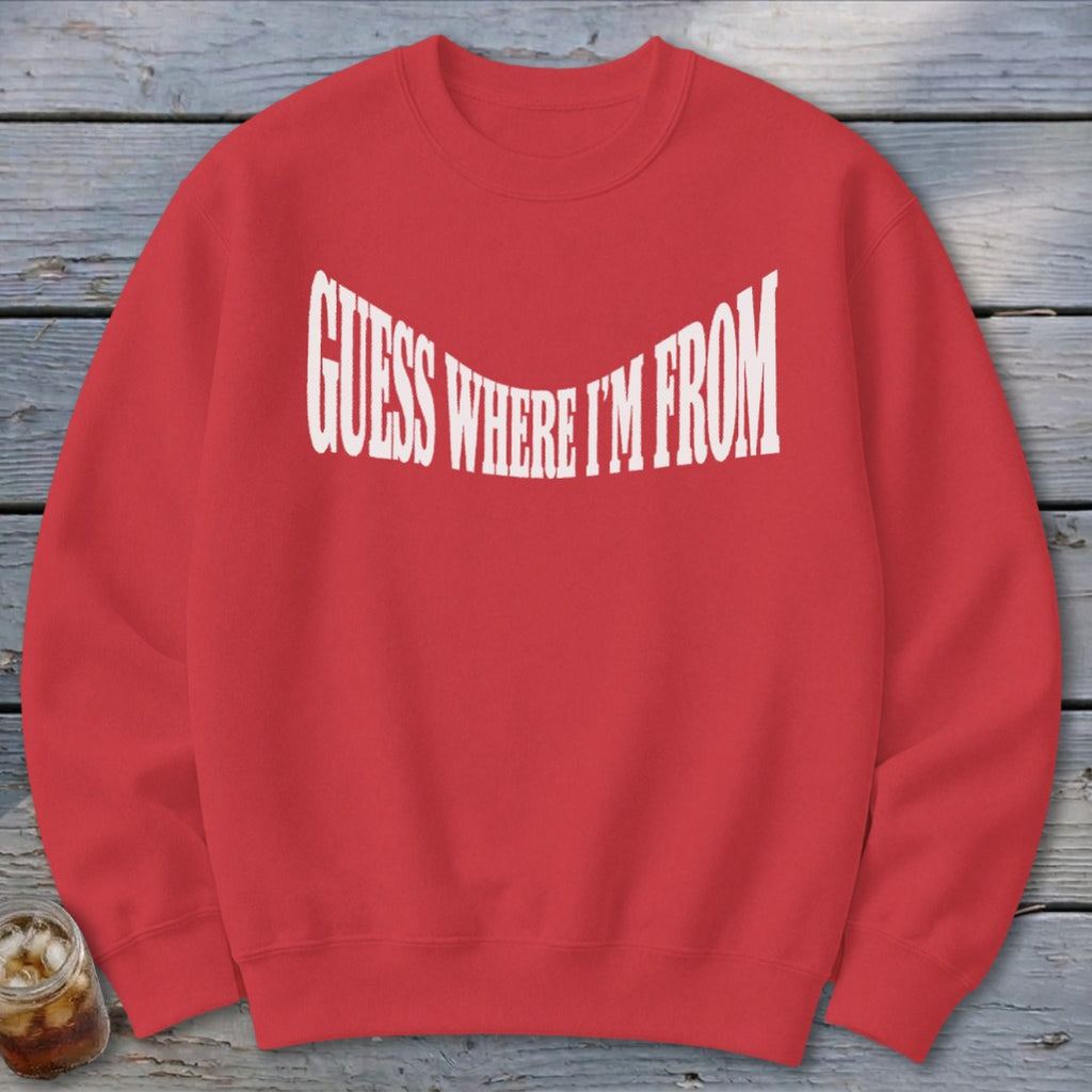 Red crewneck sweatshirt with white text "GUESS WHERE I'M FROM".