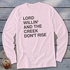 Light pink long sleeve shirt with black text reading "LORD WILLIN' AND THE CREEK DON'T RISE".