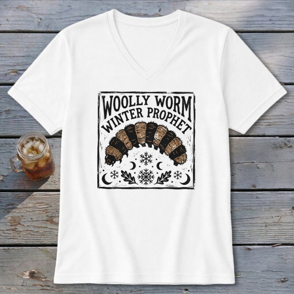 A white V-neck t-shirt featuring a black graphic of a woolly worm and text reading Woolly Worm Winter Prophet.