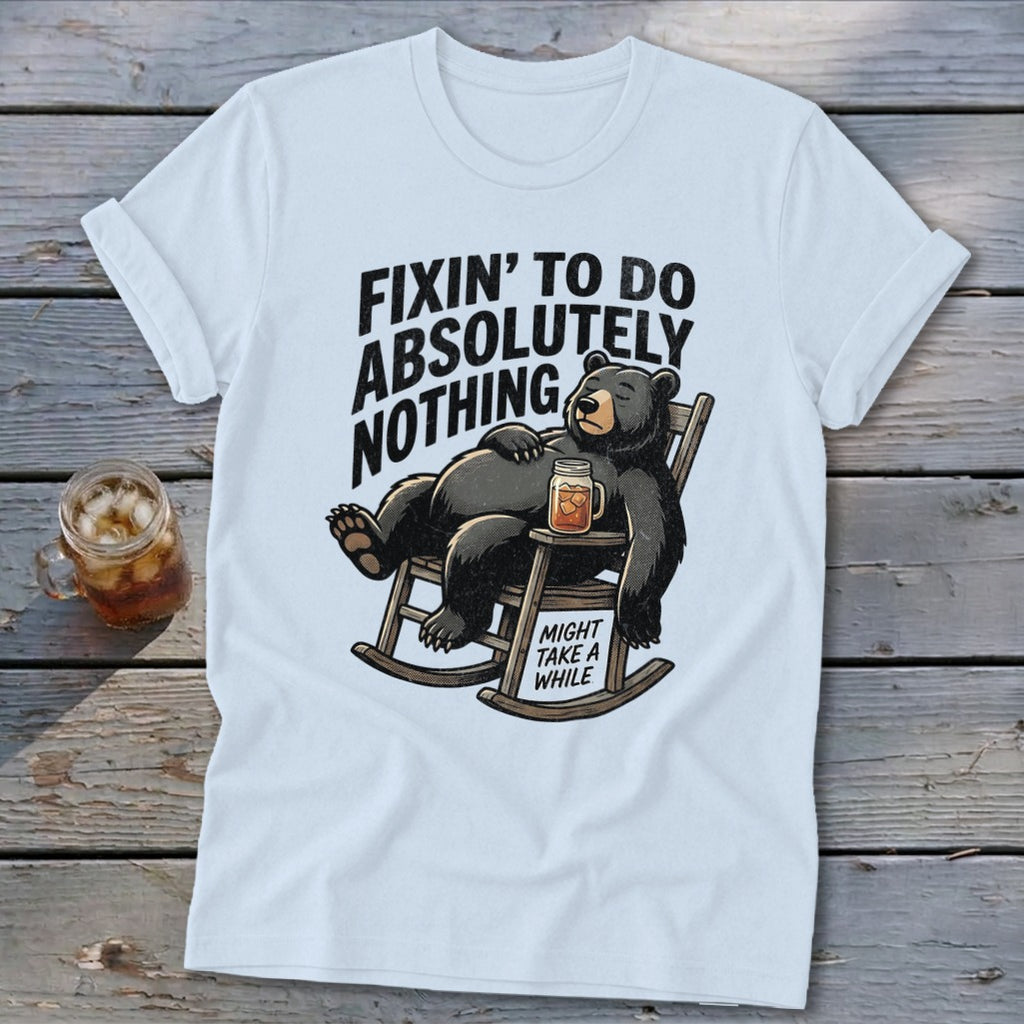 A white t-shirt featuring a graphic of a bear lounging in a rocking chair with text.
