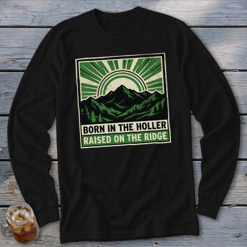 Black long-sleeve t-shirt with a green graphic featuring mountains and the text "BORN IN THE HOLLER RAISED ON THE RIDGE".
