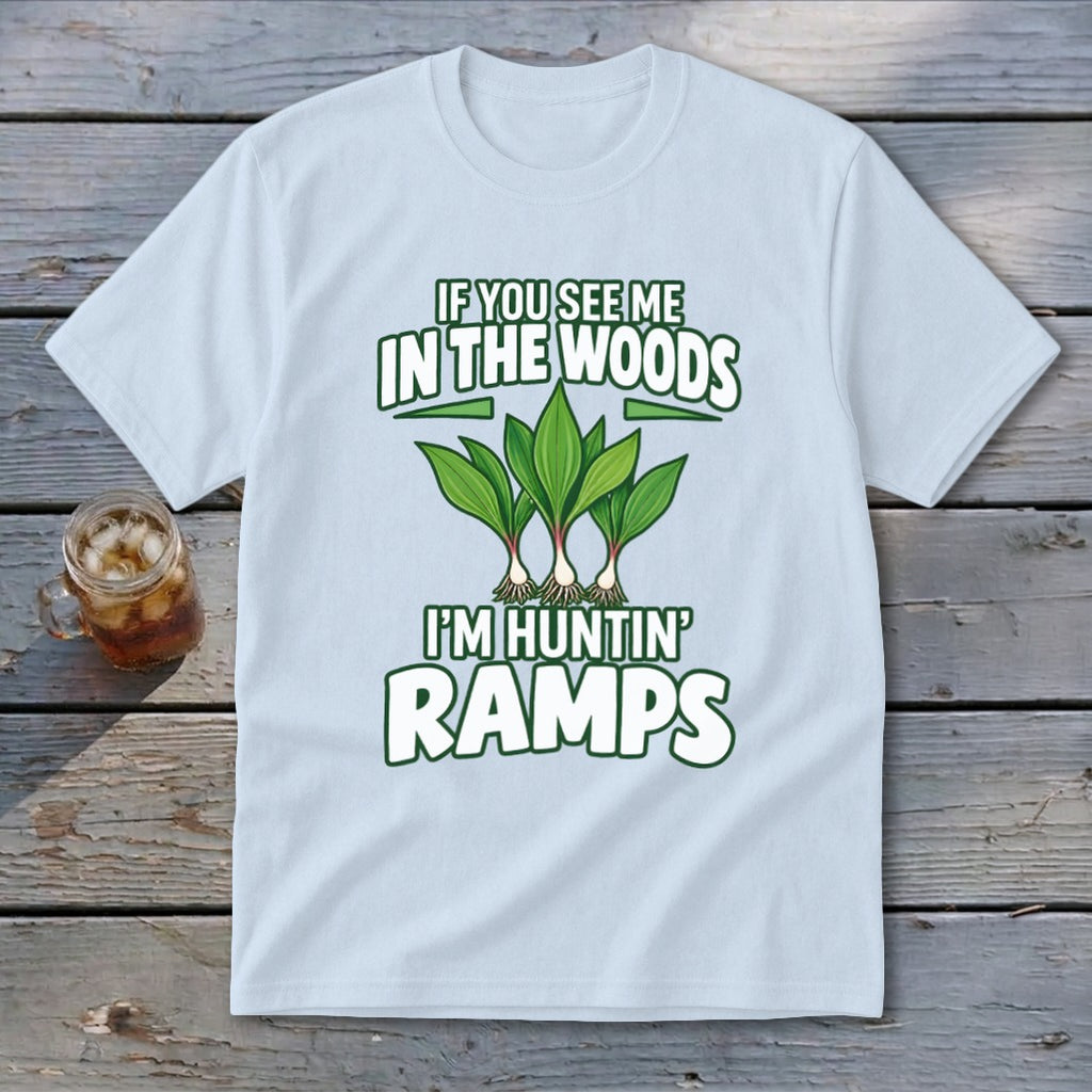 Light blue t-shirt featuring green graphic text and ramp illustrations on a wooden background.