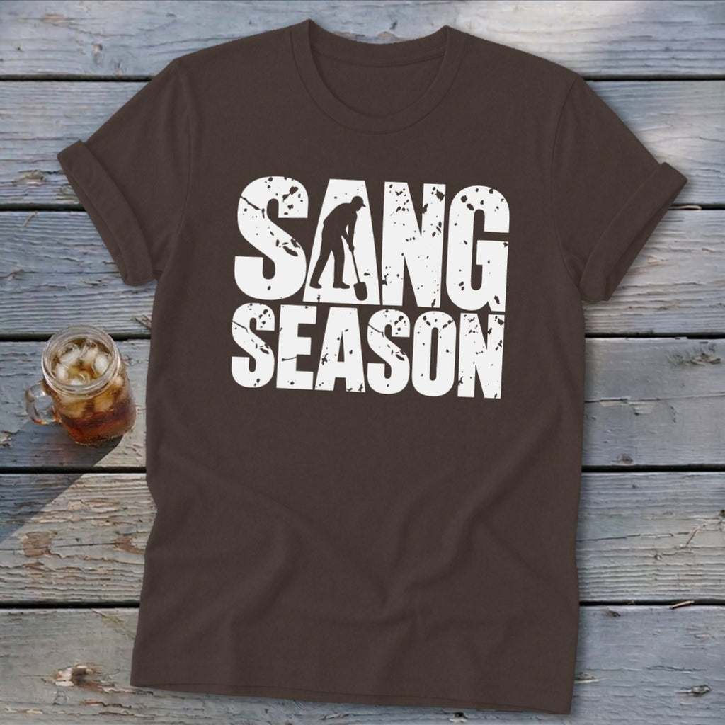 Brown short-sleeve t-shirt with white distressed text reading "SANG SEASON" and a silhouette of a digger.