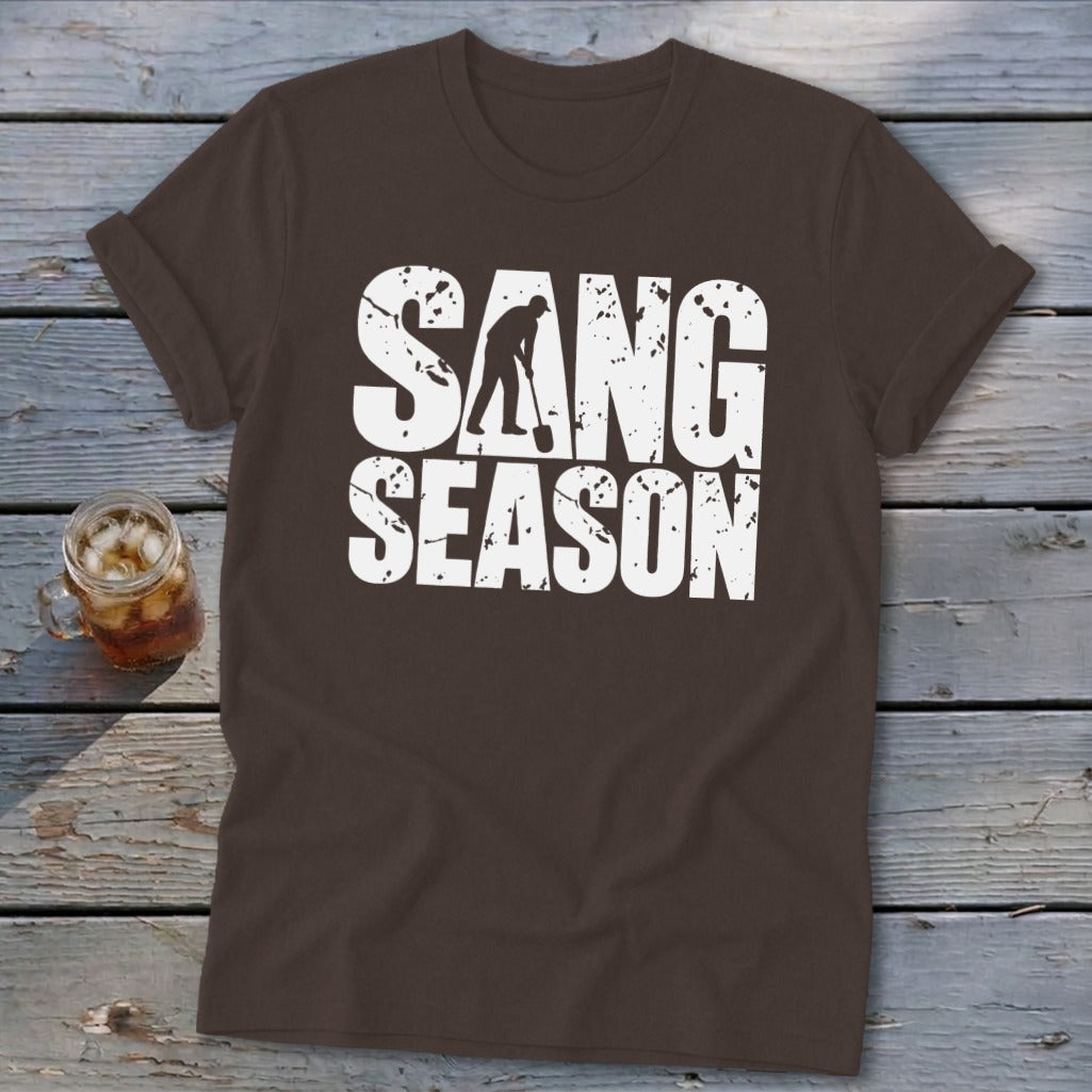 Brown short-sleeve t-shirt with white distressed text reading "SANG SEASON" and a silhouette of a digger.