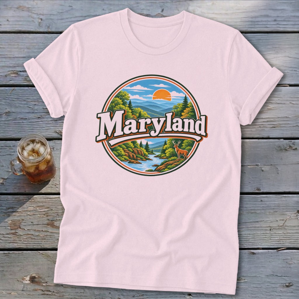 Pink t-shirt with a circular Maryland landscape graphic featuring mountains, trees, river, and a deer.