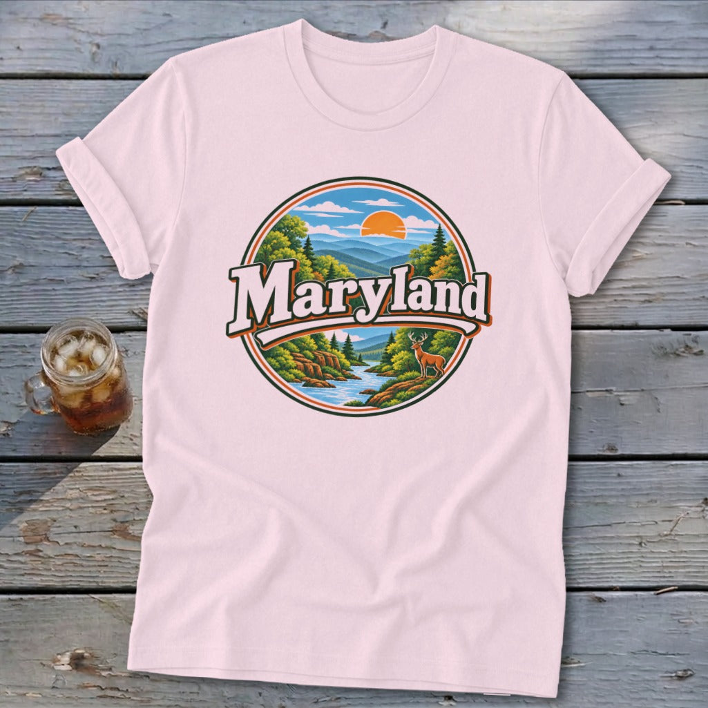 Pink t-shirt with a circular Maryland landscape graphic featuring mountains, trees, river, and a deer.