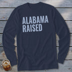 Dark blue long-sleeve shirt with "ALABAMA RAISED" printed in light blue text.