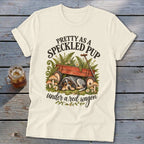 T-shirt graphic with a sleeping puppy under a red wagon and text "Pretty as a Speckled Pup".