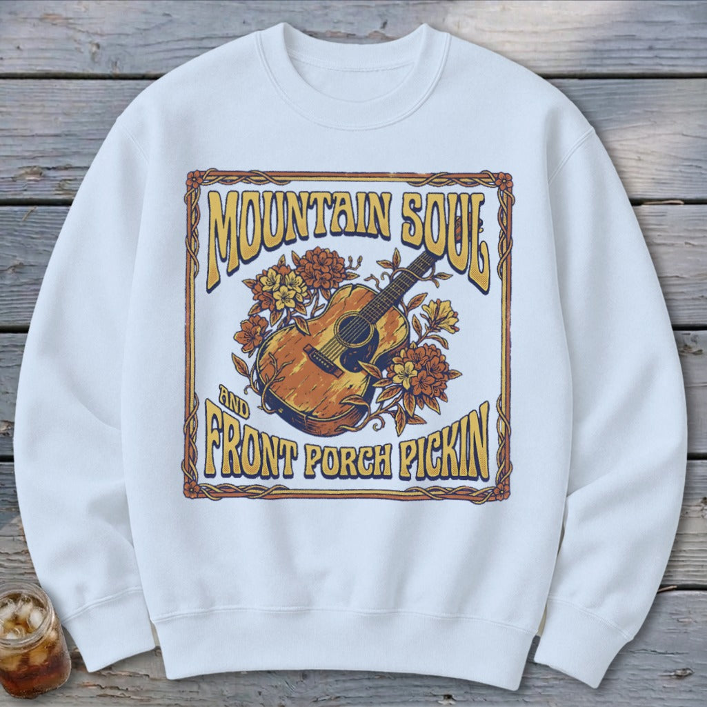 White sweatshirt with "Mountain Soul and Front Porch Pickin'" text and guitar artwork.