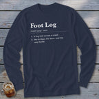 Dark blue long-sleeve t-shirt with white dictionary-style text defining Foot Log laid across a wooden background.