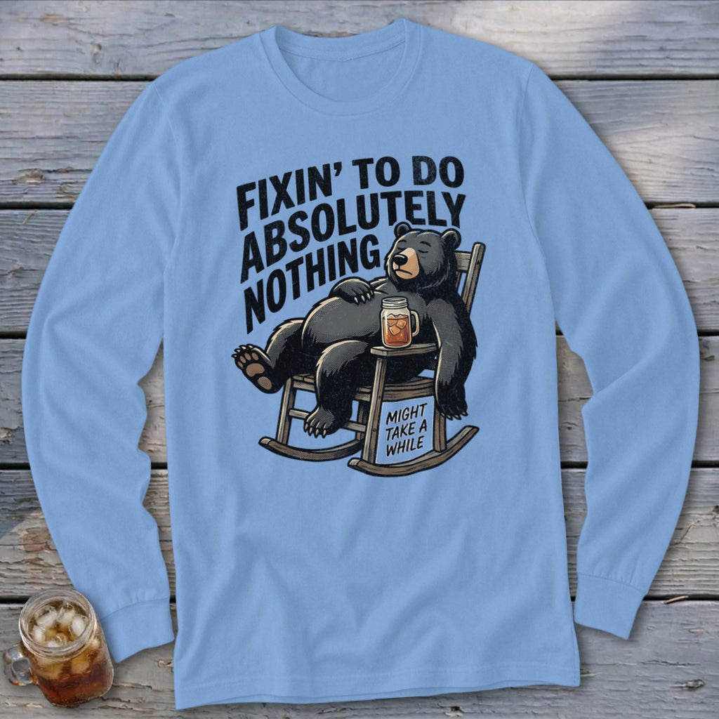 Light blue long-sleeve t-shirt with a cartoon graphic of a relaxed bear in a rocking chair.