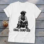 White t-shirt with black graphic of a boy in overalls holding a bucket, text reads "Coal Camp Kid".