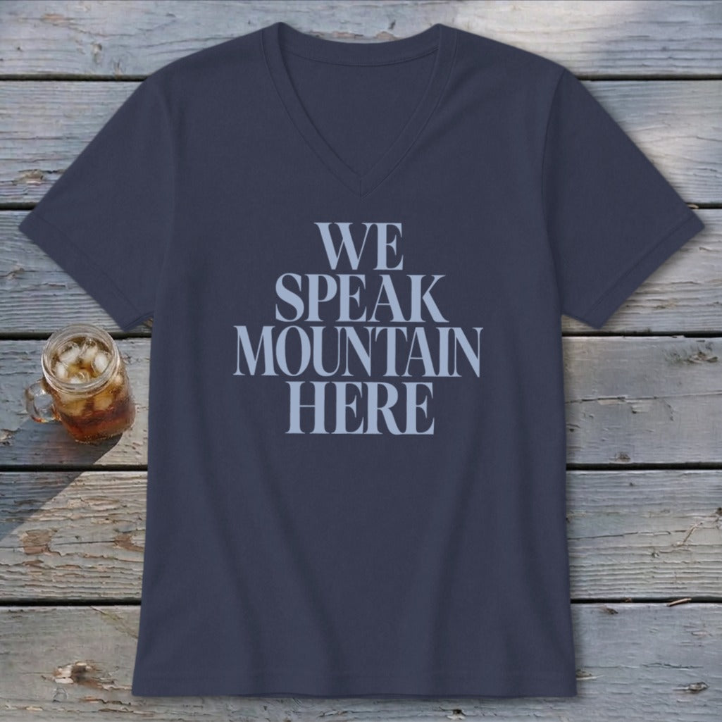 Navy V-neck t-shirt with "WE SPEAK MOUNTAIN HERE" text in light blue.
