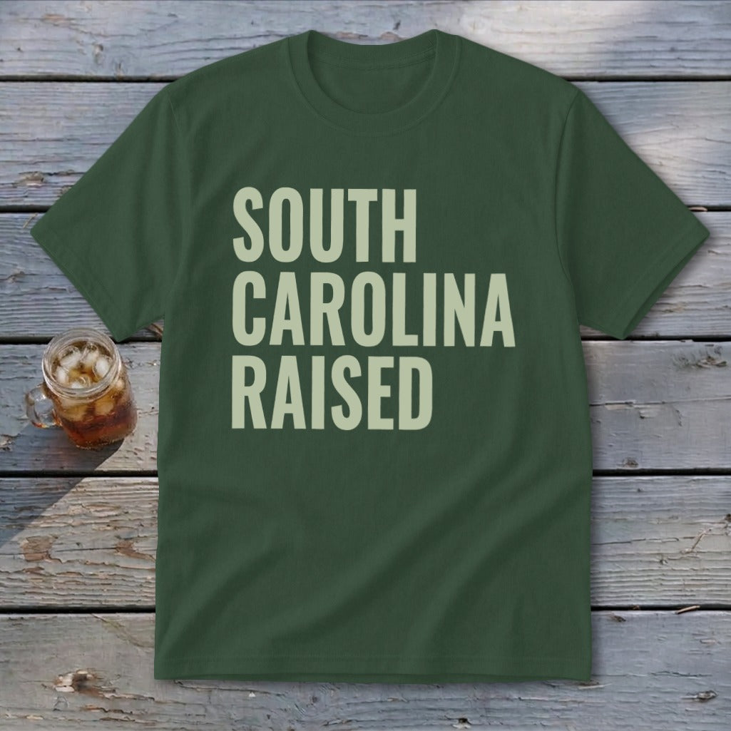 Green t-shirt with "SOUTH CAROLINA RAISED" in light beige block letters.