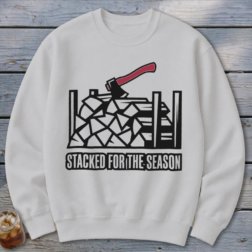 White sweatshirt with a black and red graphic of an axe in stacked firewood, text reads "STACKED FOR THE SEASON".